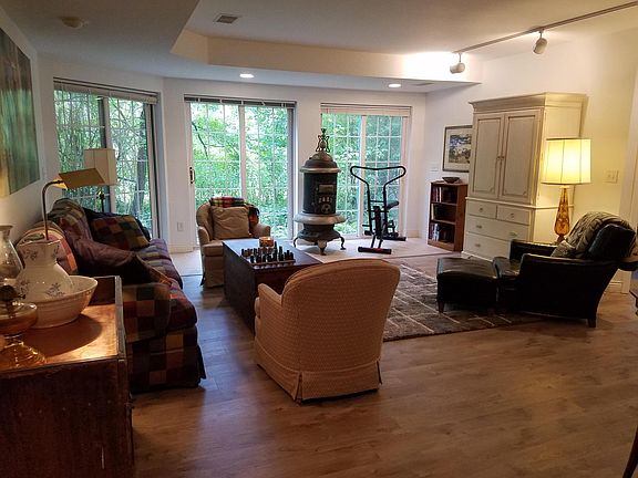 Common space sitting area. TV in the cabinet and exercise bike for tenant use.