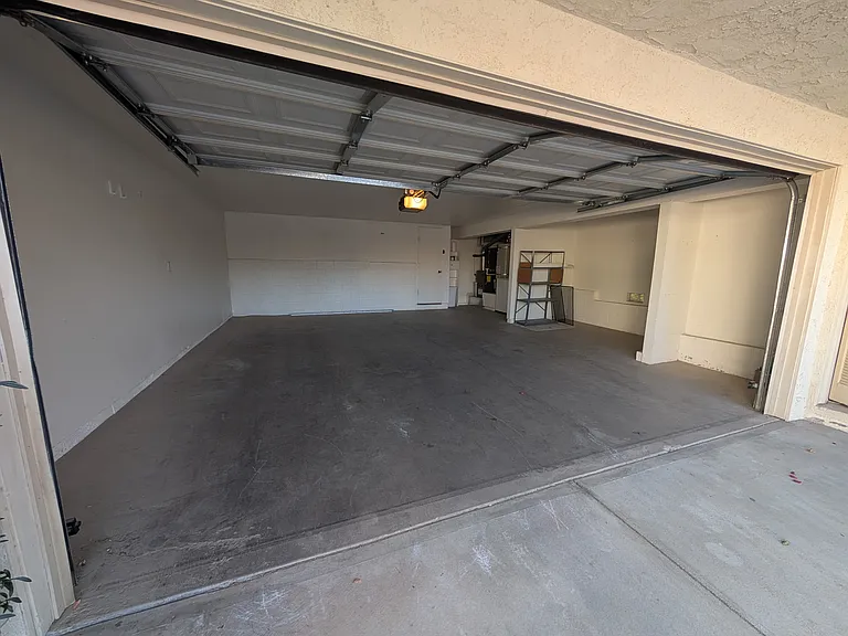 Attached two car garage with extra space for storage and EV charging.