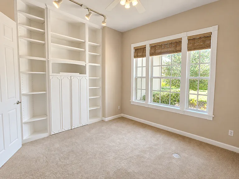 Private Office with Custom Built-ins located in Right Wing of home with Primary Suite