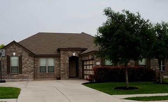 Well taken care of lawn, front of home with side entry garage