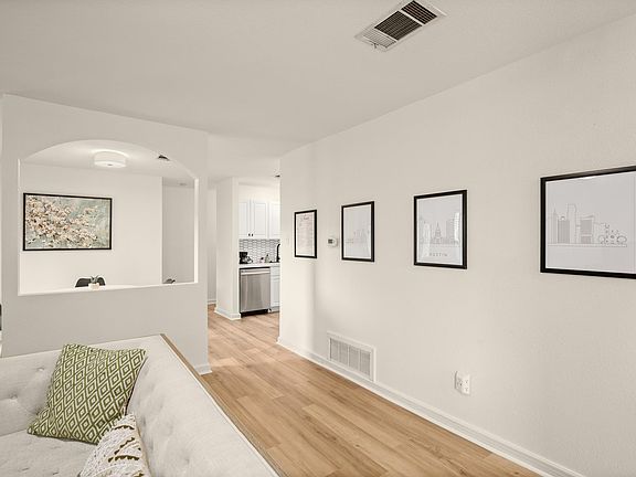 entry hallway with living room and dining room pictured