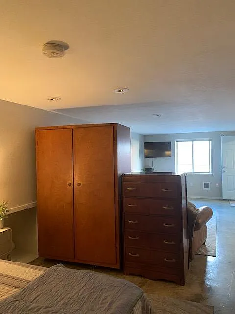 Closet and dresser between sleeping area and living area