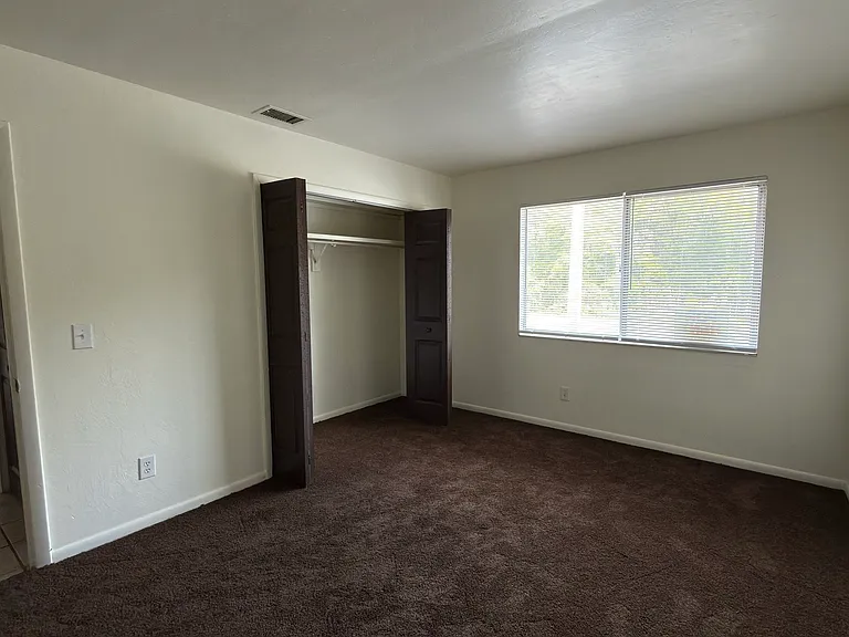 Large bedroom #1 with brand new coffee colored carpet.