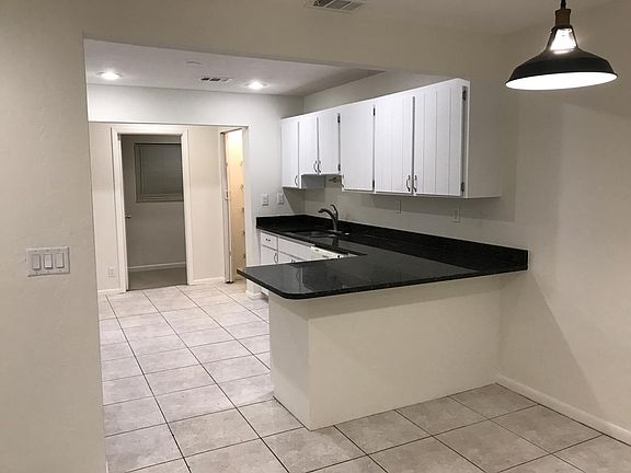 Bright Kitchen with plenty of counter space & cabinets; Laun