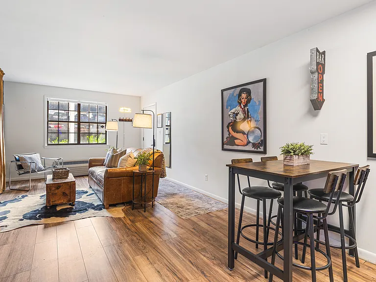 Cozy living room with a smart TV and a sleeper sofa. Opens up into the kitchen. No stairs in this condo and located on the ground level, for easy access.