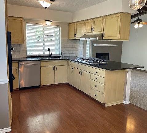 Kitchen has new granite counter tops, the cabinets are tea stained and distressed.