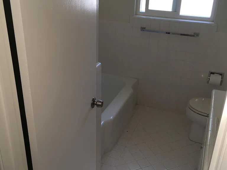 Upstairs bathroom, shower, tub, toilet and hand sink with storage under