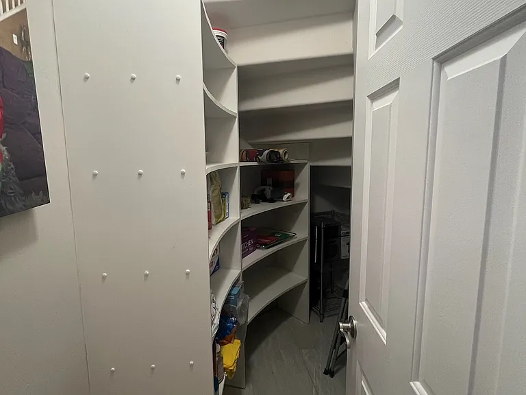 under stairs storage space. Can be used as a food pantry or just extra storage.
