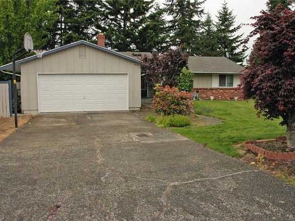 Another view of the front of the home showing the large flat front driveway & newer garage door!