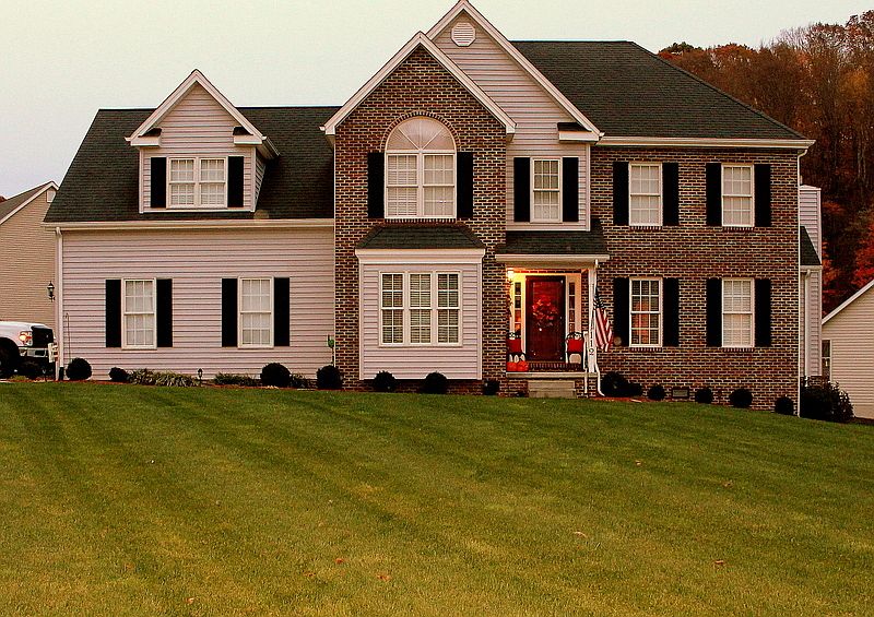 Large Level Lot : Brick & Vinyl Siding. 30 Year Shingle. 2-Car Garage located on side of home.