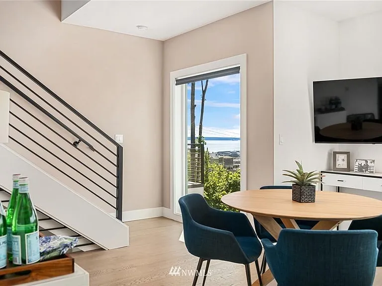 Dining area with floor-to-ceiling windows overlooking the water.