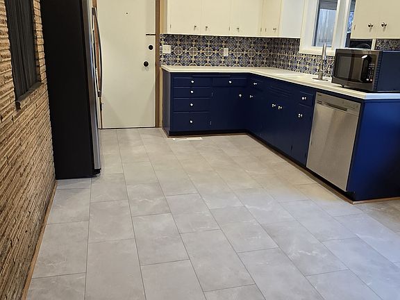 Newly remodeled kitchen with updated lighting, flooring and appliances.