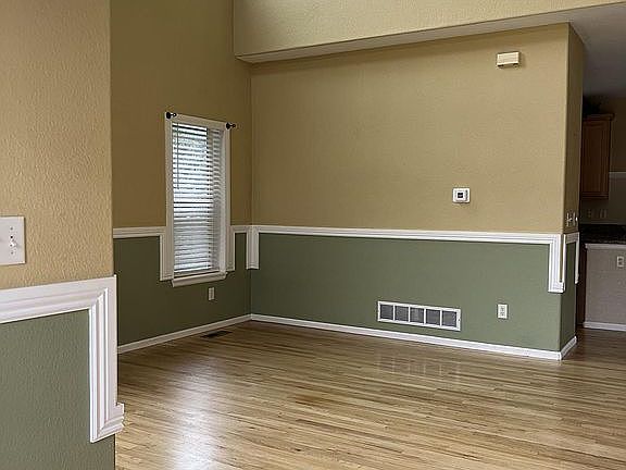 Well-lit formal living Space with vaulted ceiling
