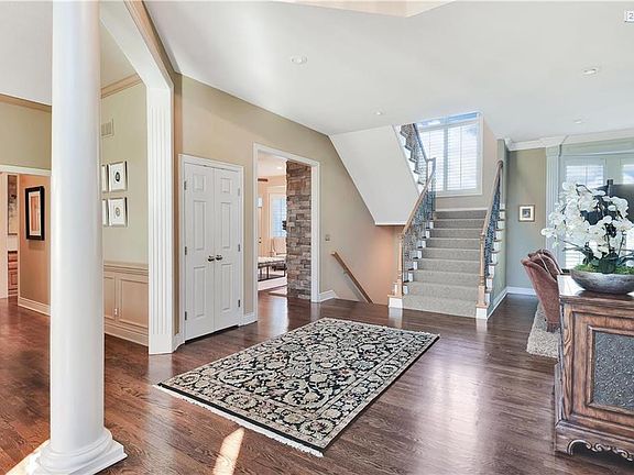 Light filled entry hall, one staircase up, hardwoods everywhere, left is to dining or hearth room, right is to study or the great room...your choice!