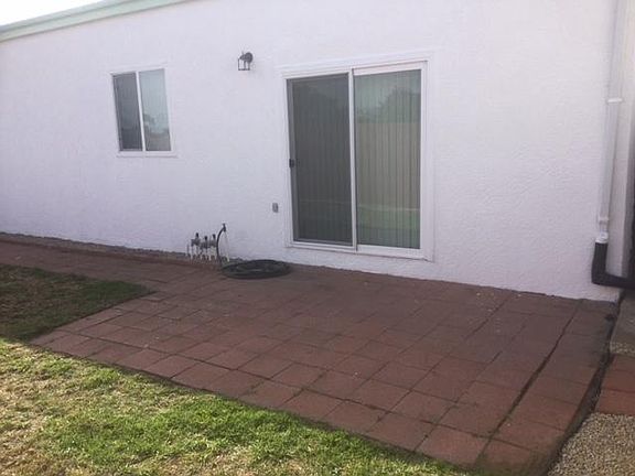 Slider door leading in and out of the main bedroom