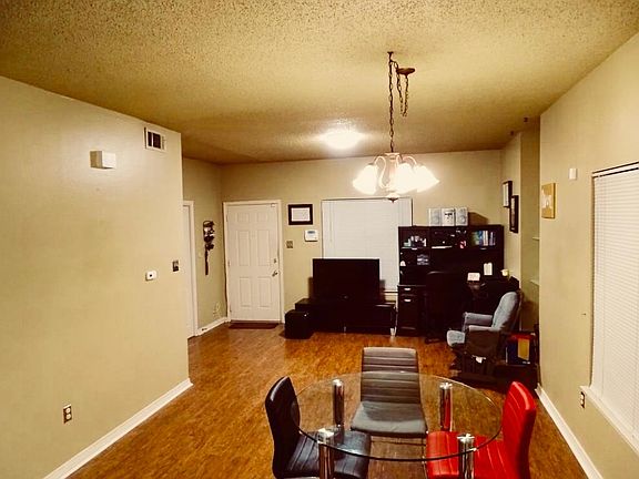 Living room has great natural light and hardwood floors.
