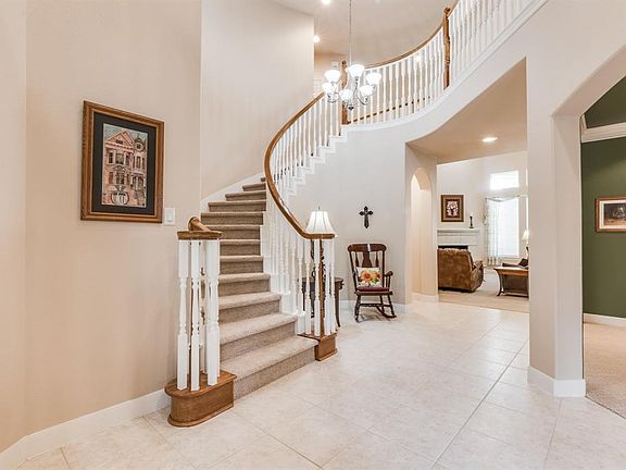 Elegant entry way with dramatic spiral staircase and soaring ceilings!
