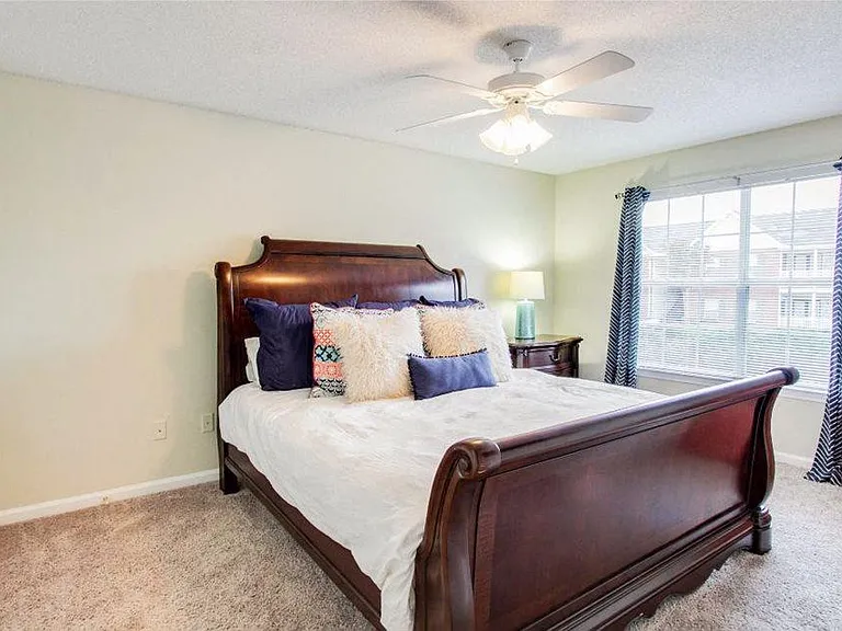 Bedroom with ceiling fan and carpet flooring