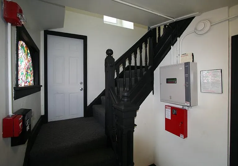 Building hallway with 24/7 fire monitoring system