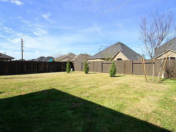 You'll appreciate the size of the Back Yard that is fully fenced and offers a lush lawn with various trees and landscaping.