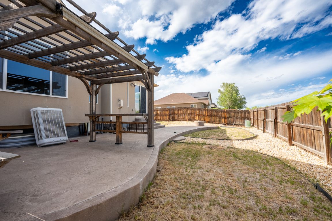 Backyard with stamped concrete, pergola, and fire pit
