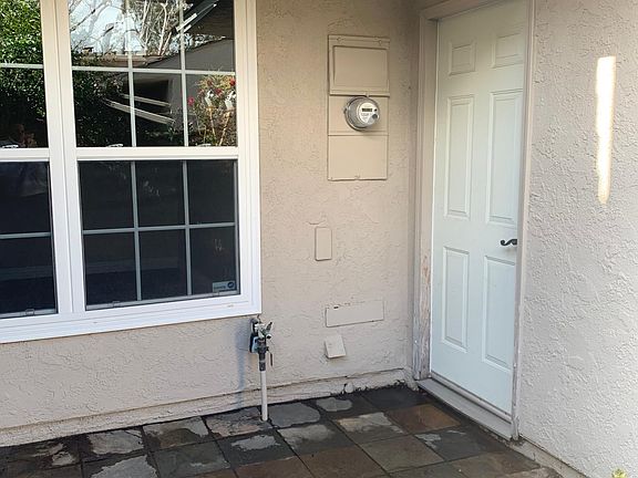 Cute front courtyard patio between garage and front door
