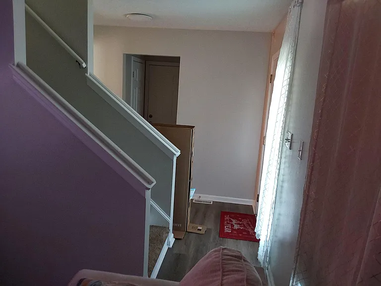 Welcoming entryway with stair access, durable flooring, and a sidelighted front door that brings in natural light.