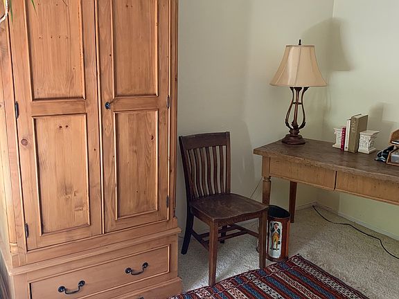 Bedroom with single bed and work area.