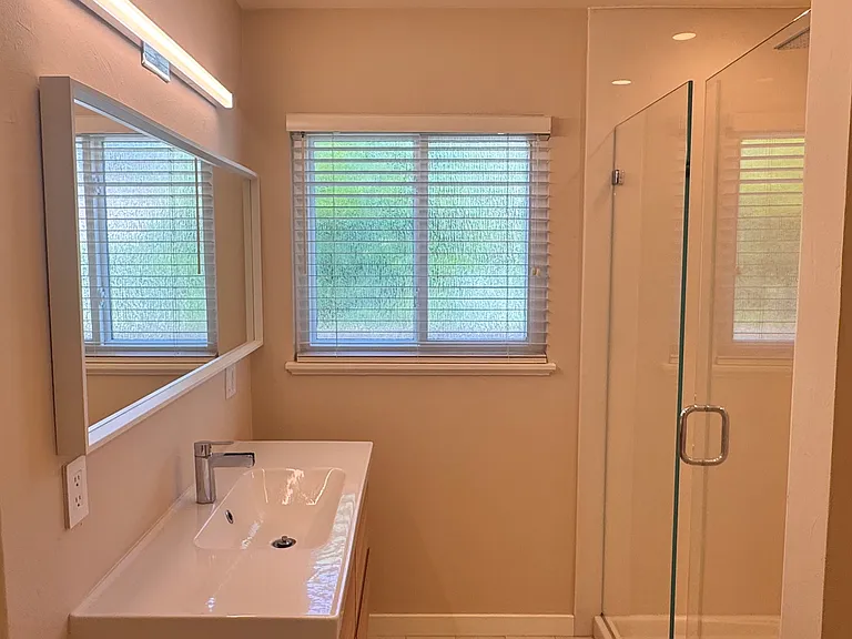 ...as well as bright lighting, Italian ceramic tile floors, and a modern floating vanity.