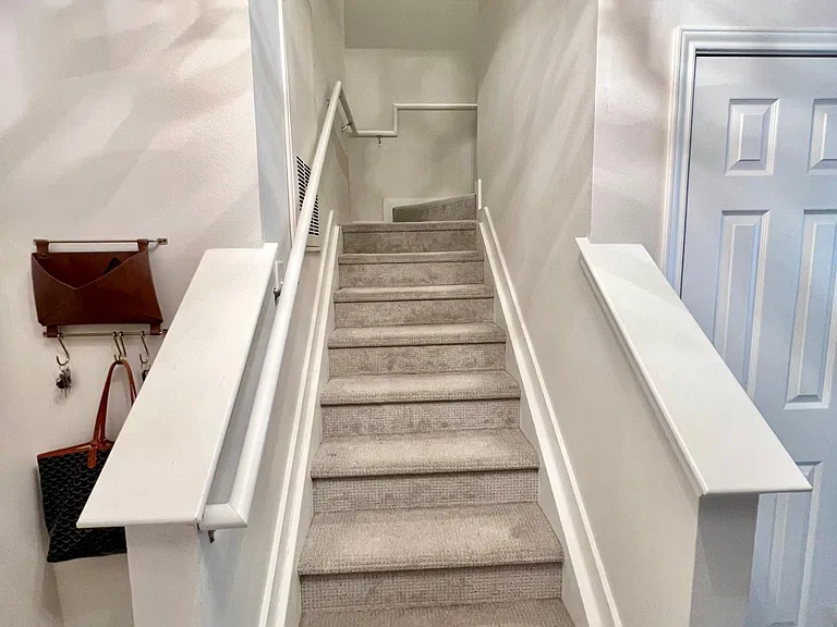 Interior stairs to the second floor where bedrooms and bathrooms are located.