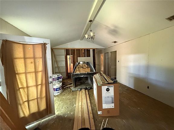 Spare room with attic access and lofted ceiling with beams
