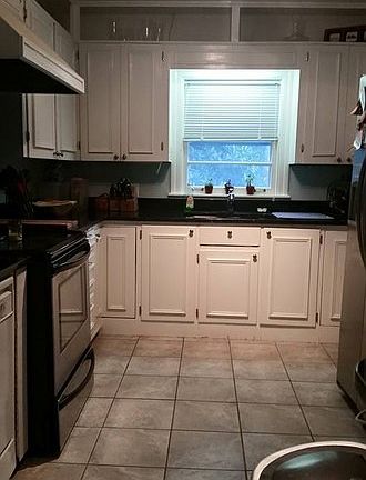 Kitchen
						:
						also has a bar area that opens into the sunroom