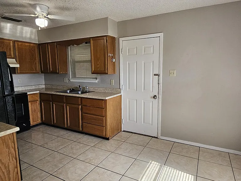 Tile flooring in kitchen/dining area.