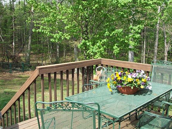 View from deck of large, fenced-in backyard.