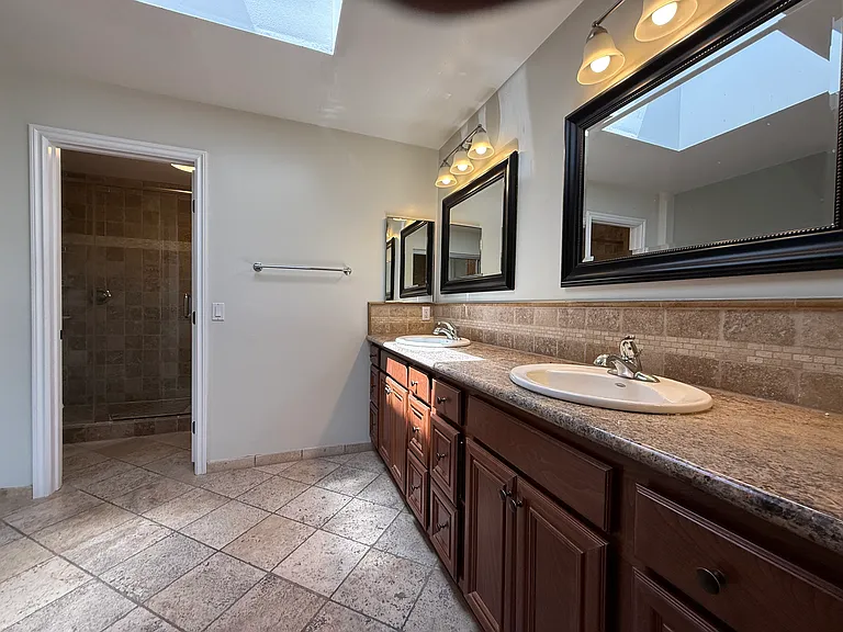 Double sink Primary bath with tub and shower through door.