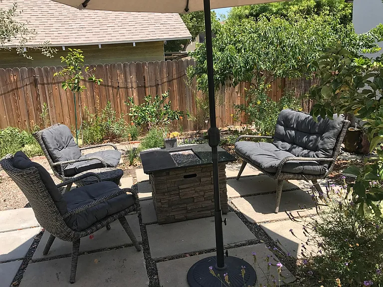 Enjoy this Gorgeous Backyard filled with Fruit Trees, Colorful Flowers, and a Firepit Seating Area as part of your tranquil living experience in this Charming 2 BDR/1 BA Retro Row Duplex Apartment.