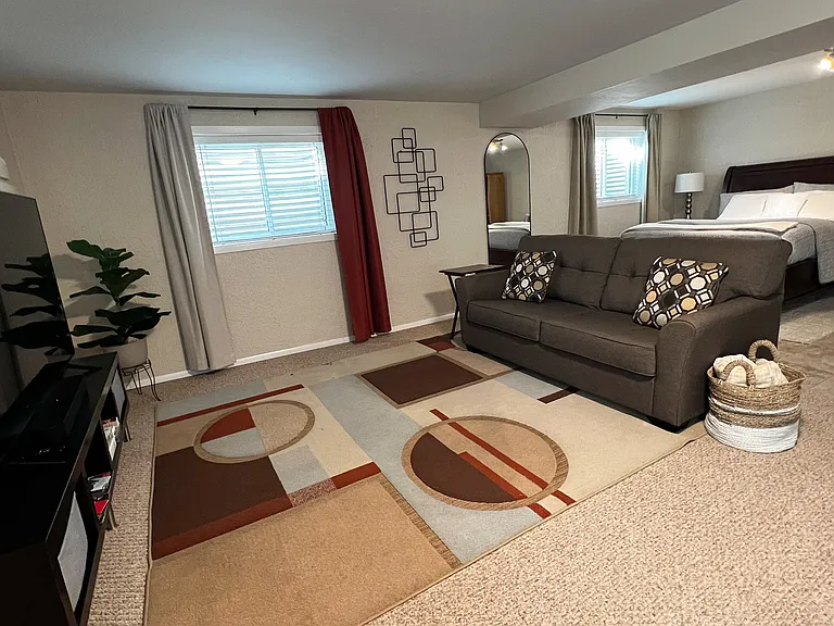 Unwind in the cozy living area with a 65" Smart TV for streaming your favorite shows.