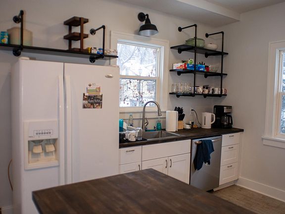 Kitchen with lots of storage, butcher block countertops and dishwasher.