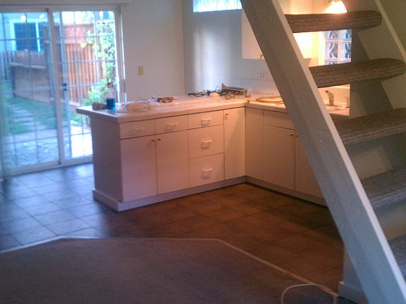 View of the kitchen and patio/backyard from the living area
