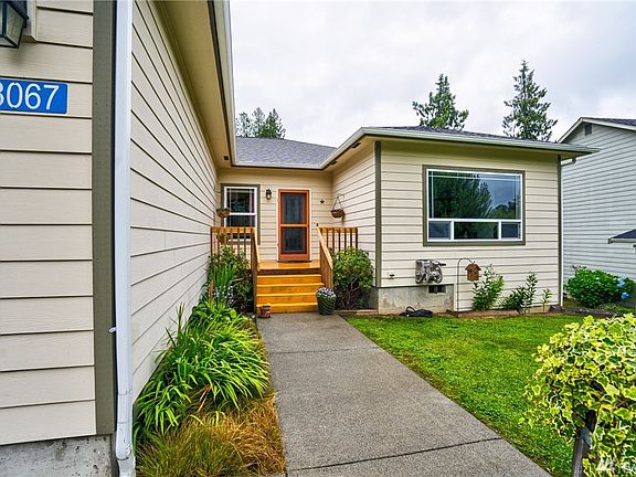 Front walk way and deck area. Lush lawn and tastefully landscaped!