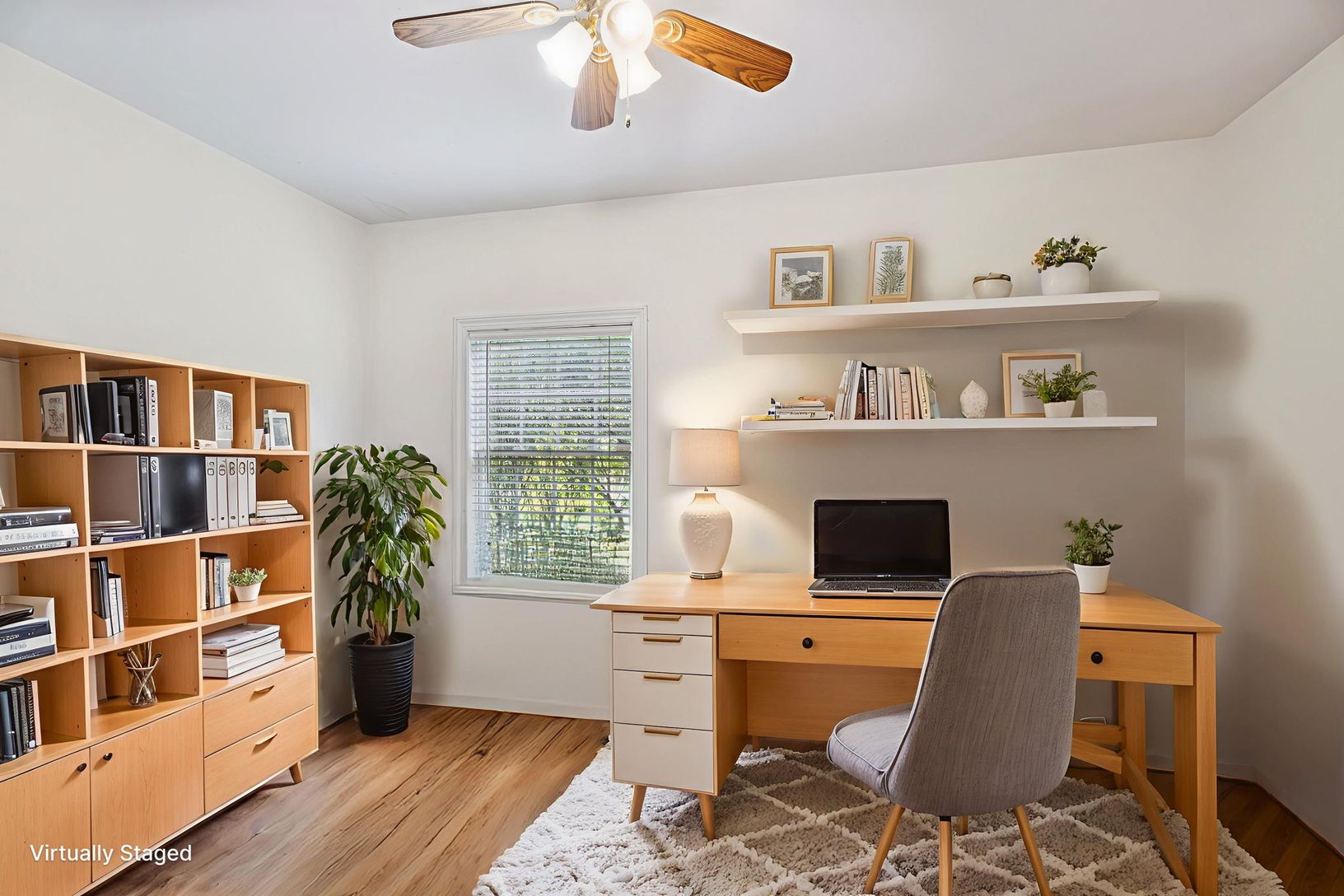 Bedroom / Office space with light wood-style flooring and a ceiling fan.