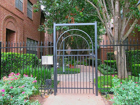 Pedestrian gate on W. Main is entrance to beautiful, shady courtyard, with lush landscaping, large p