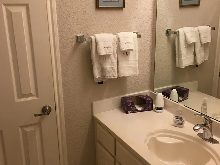 Upstairs full bath has large vanity with separate door to tub/shower and toilet.