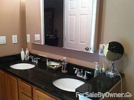 Main En Suite
						:
						Garden tub w/ large pane window is left of granite dual vanity. Shower too!