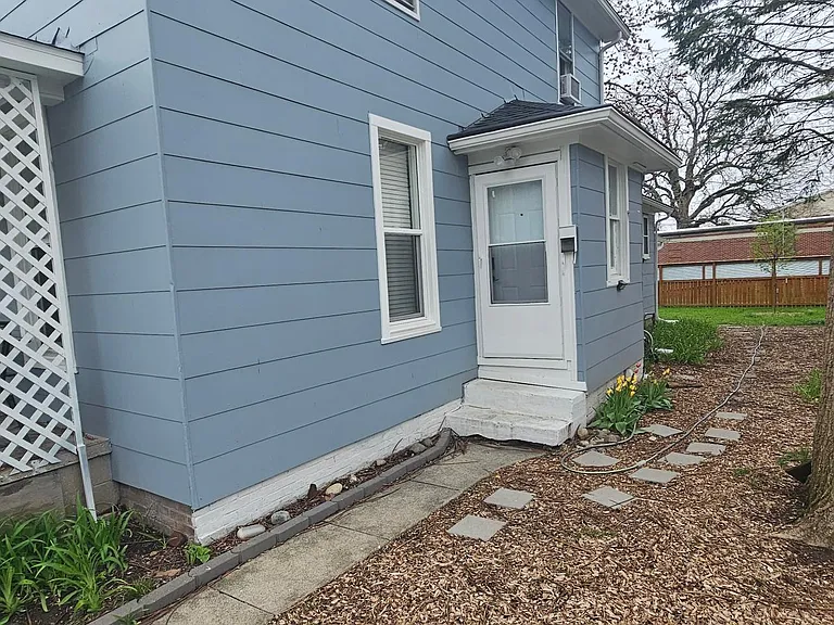Upstairs Entrance, and side yard leading to partially fenced in backyard