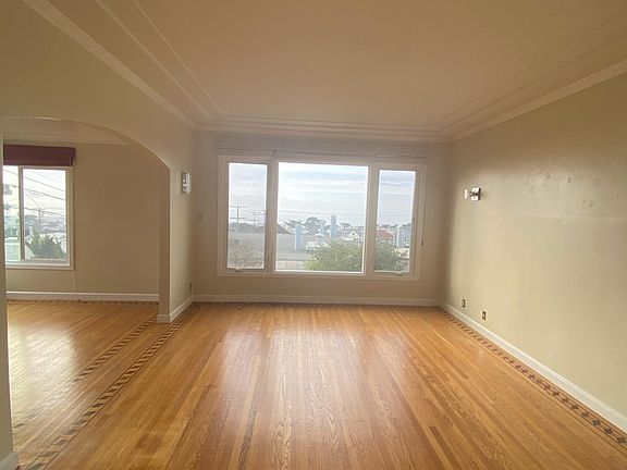 Another view of living room on the right and dining room on the left
