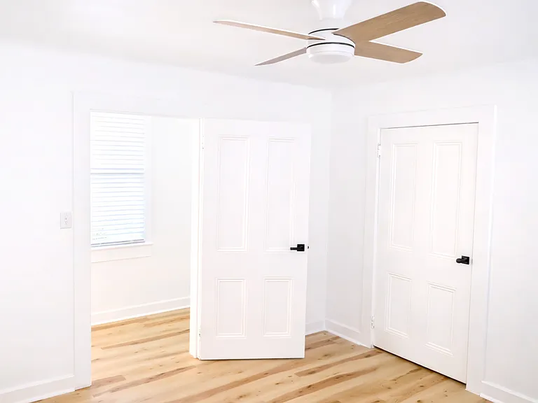 Second bedroom showcasing a functional layout with easy access to a spacious walk-in closet