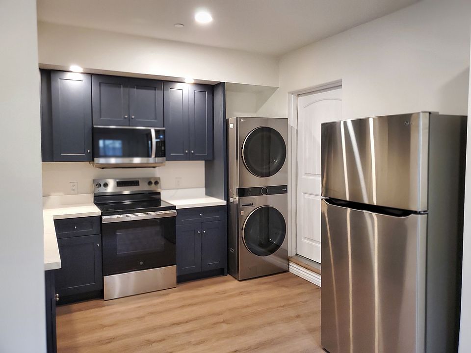 Custom built kitchen cabinets & counter top.
Includes new kitchen appliances- Refrigerator, range/oven & built-in microwave.
Inside tower washer & dryer.