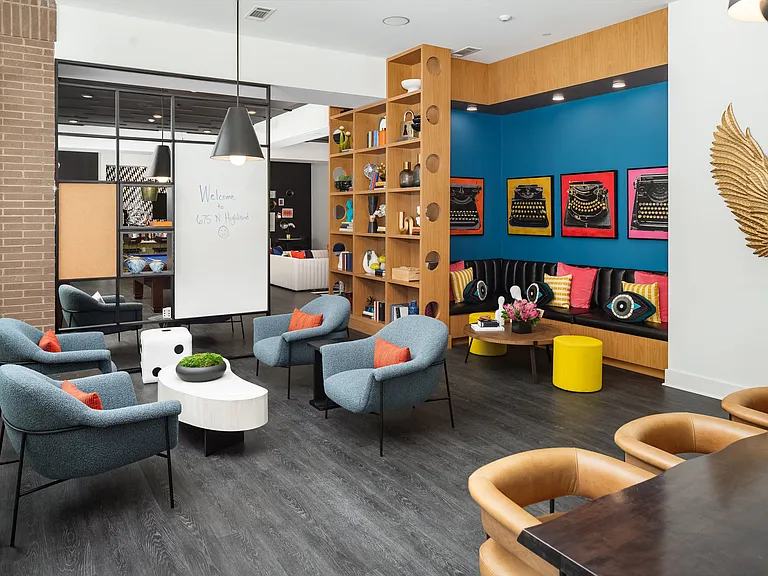 Playful Community Lounge with Typewriter Art, Shelving Display, and Accent Wall
