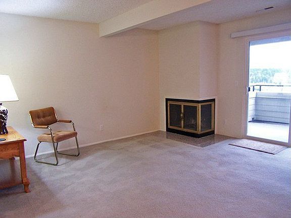 living room with fireplace, view and door to deck